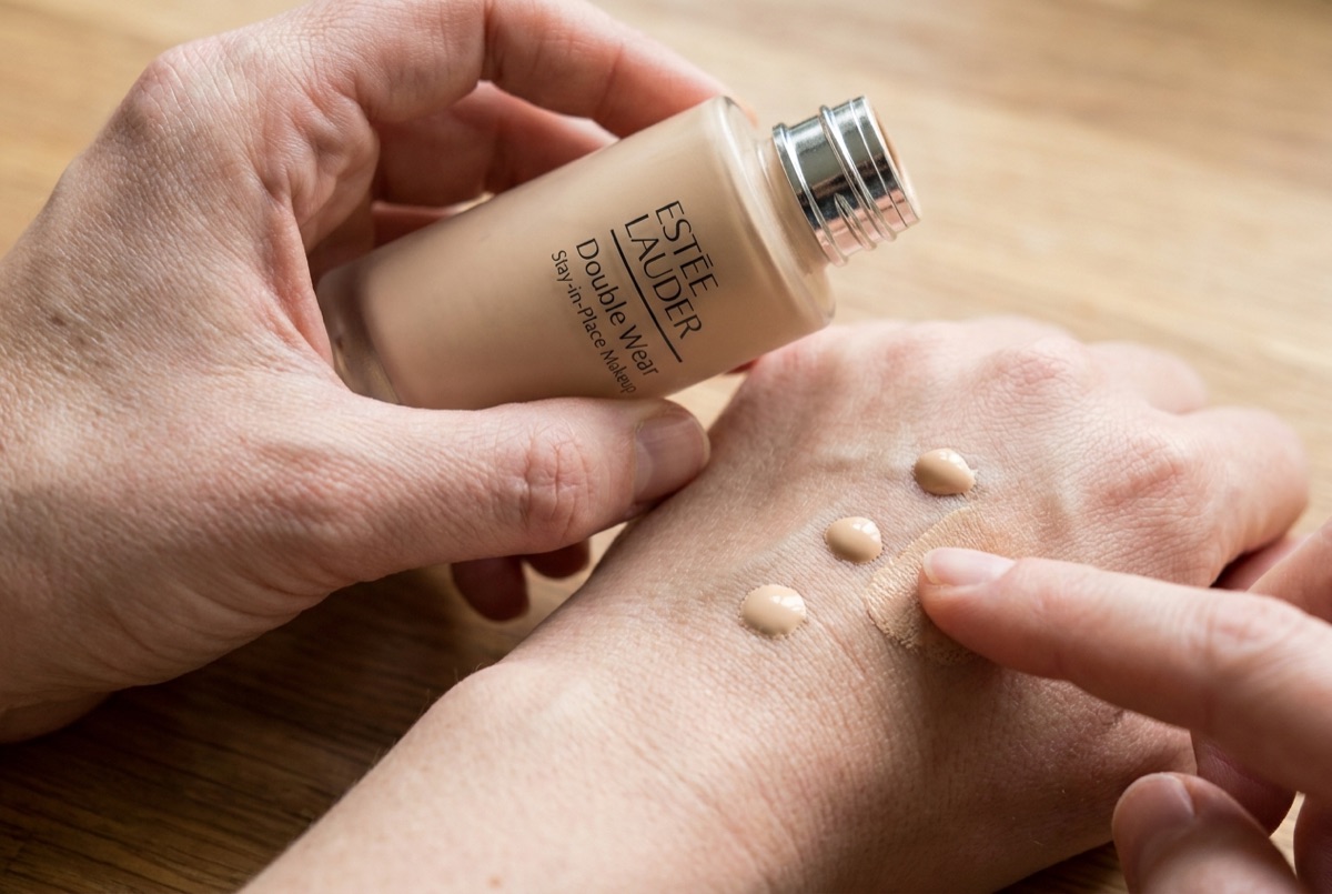 Estée Lauder Double Wear being dotted and blended on the back of a hand