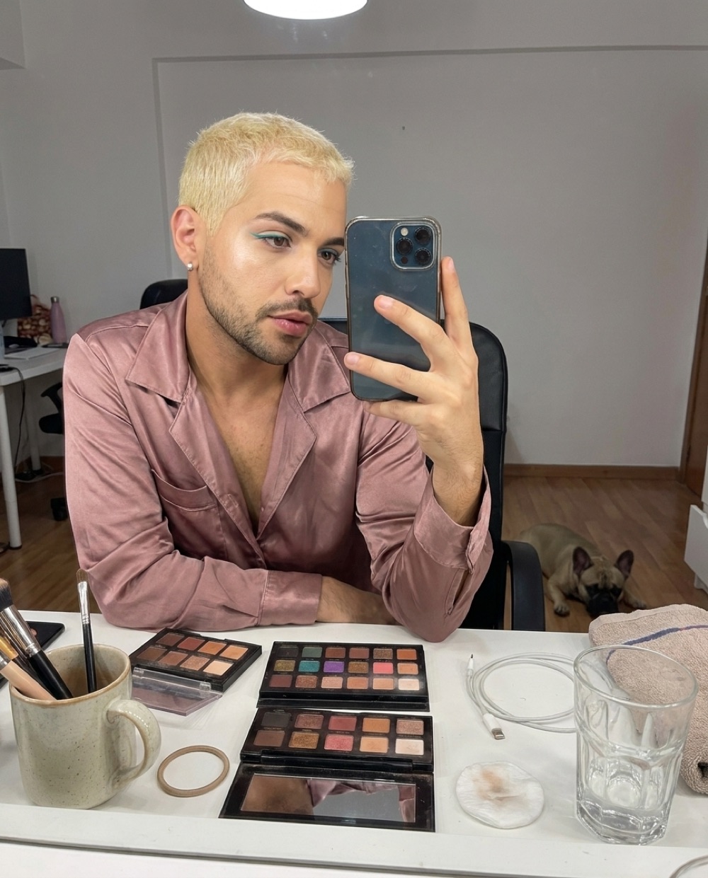 Danny Rose at his vanity at home, phone in hand, dog nearby
