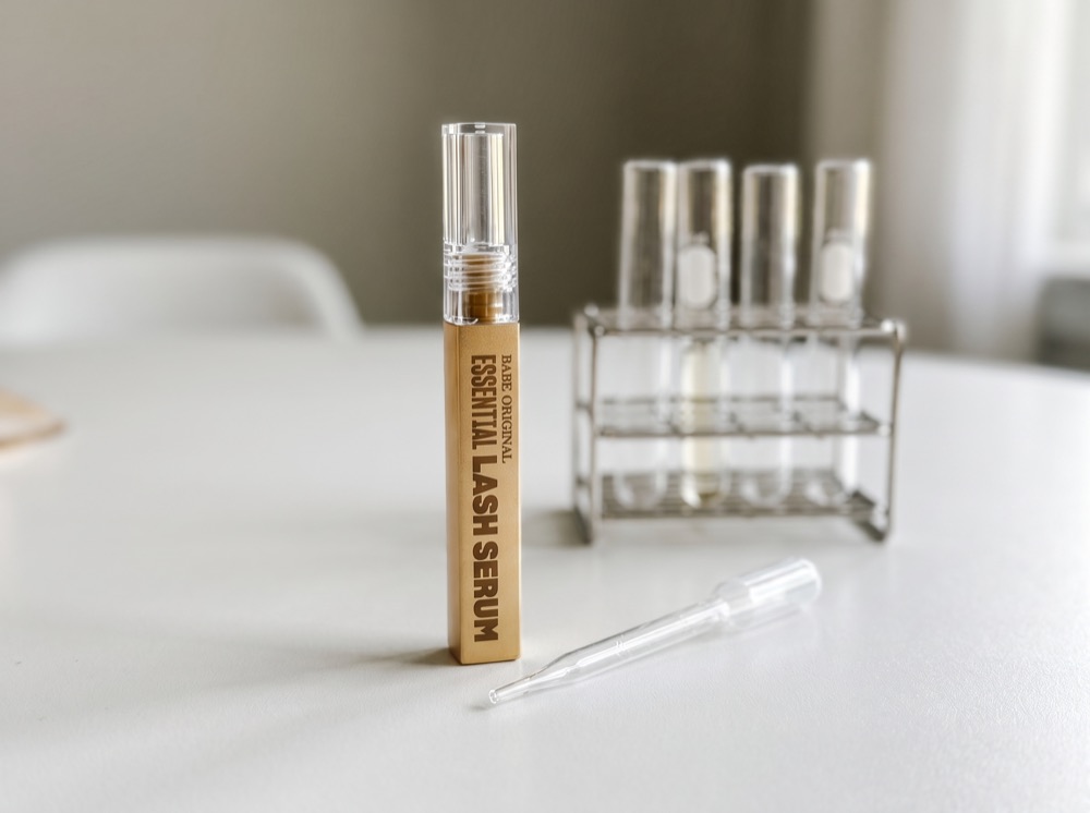 Babe Original Essential Lash Serum on the test bench with pipette and test tube