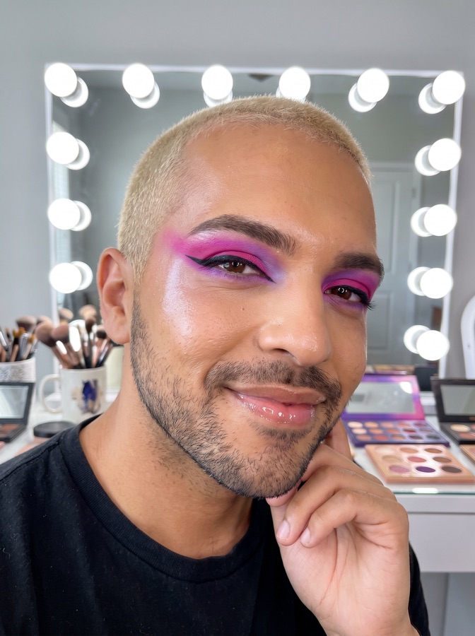 Danny Rose, makeup artist, in a bold pink glam eye look at his studio vanity