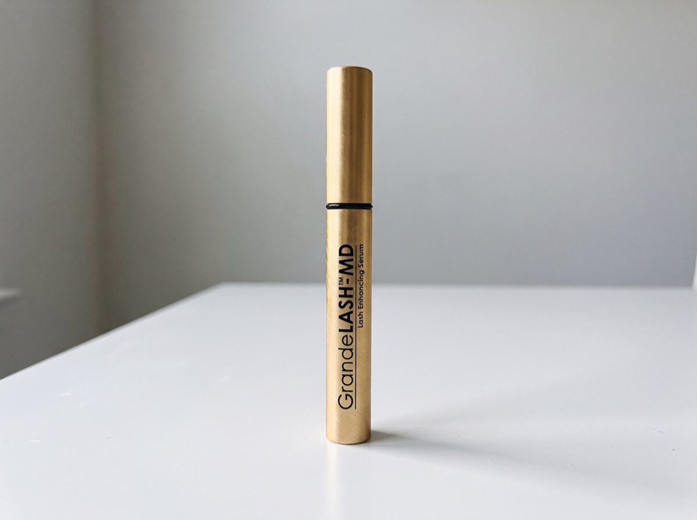 GrandeLASH-MD Lash Enhancing Serum standing on a white tabletop