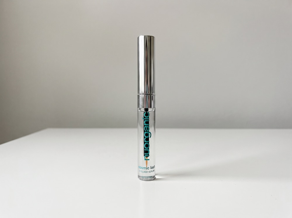 NuOrganic Cosmic Lash Serum standing on a white tabletop