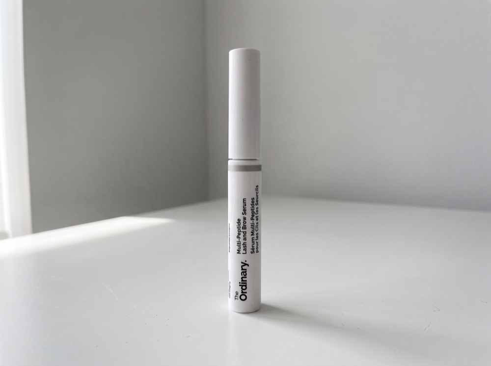 The Ordinary Multi-Peptide Lash and Brow Serum standing on a white tabletop