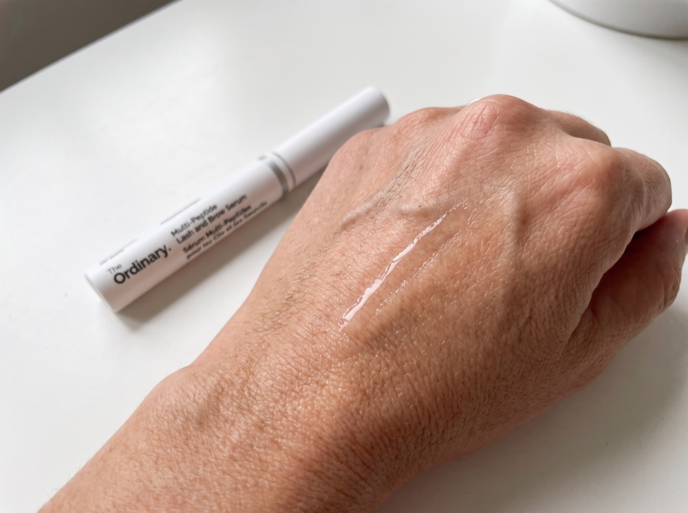 Serum swatch of The Ordinary Multi-Peptide Lash and Brow Serum on the back of a hand