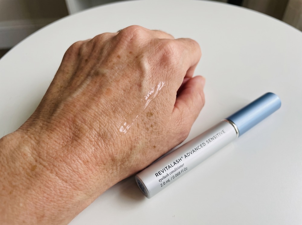 Serum swatch of RevitaLash Advanced Eyelash Conditioner on the back of a hand