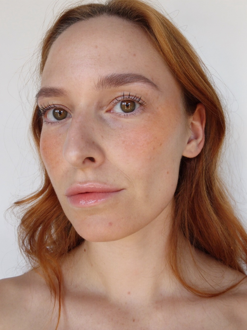 Natural everyday makeup on freckled skin in window light