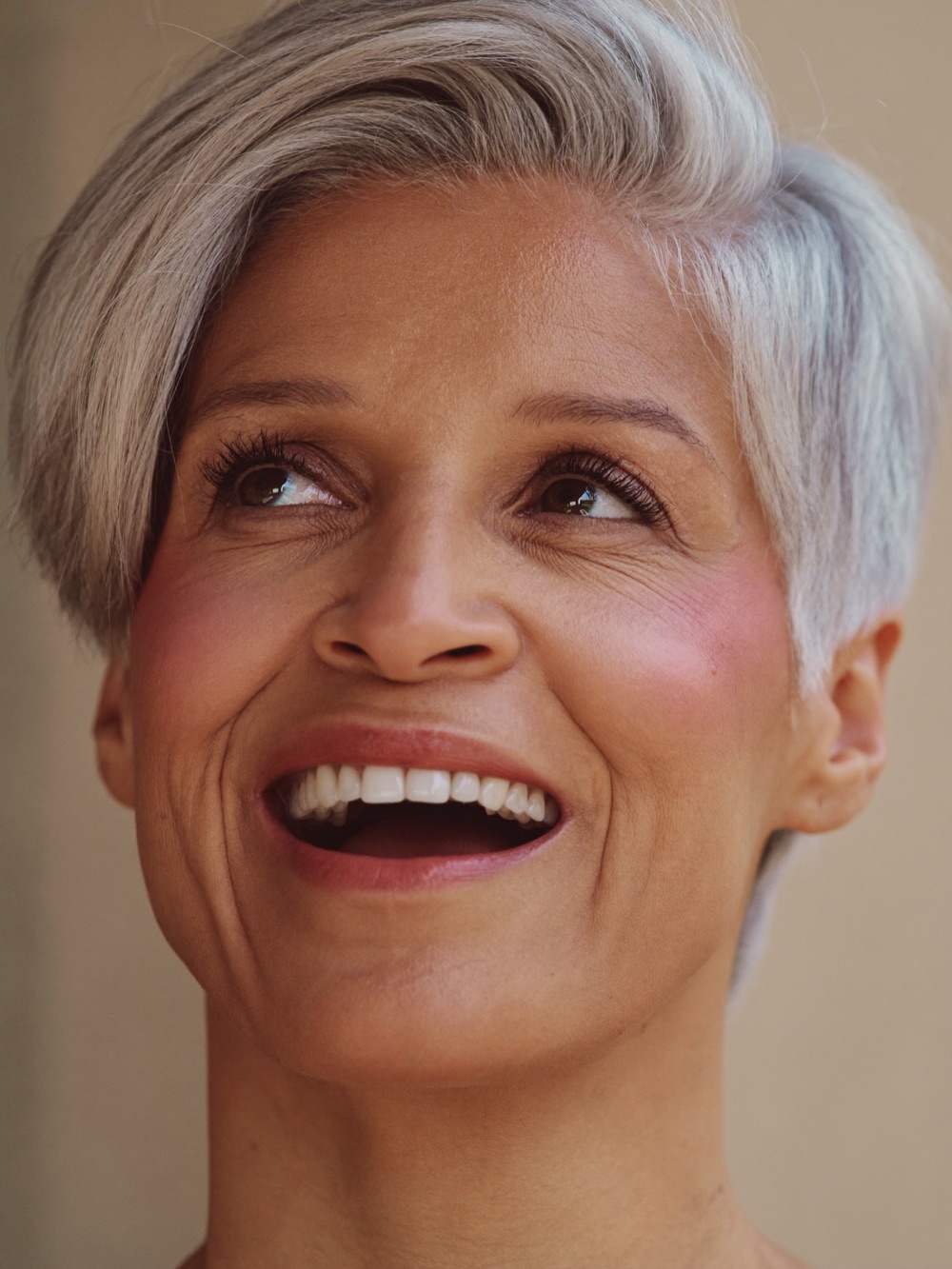 Woman in her sixties with fresh satin-finish makeup and defined brows