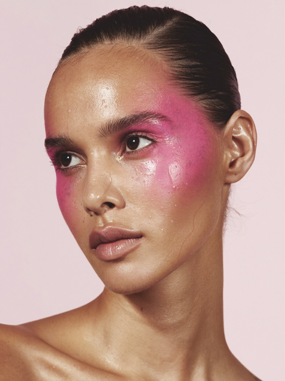 Editorial beauty look with bright pink blush carried up to the temples
